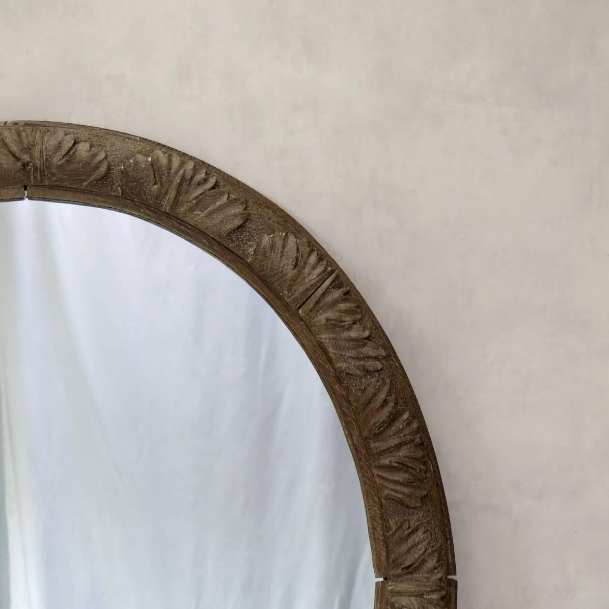 Elegant oval carved oak frame, fitted with a new mirror.