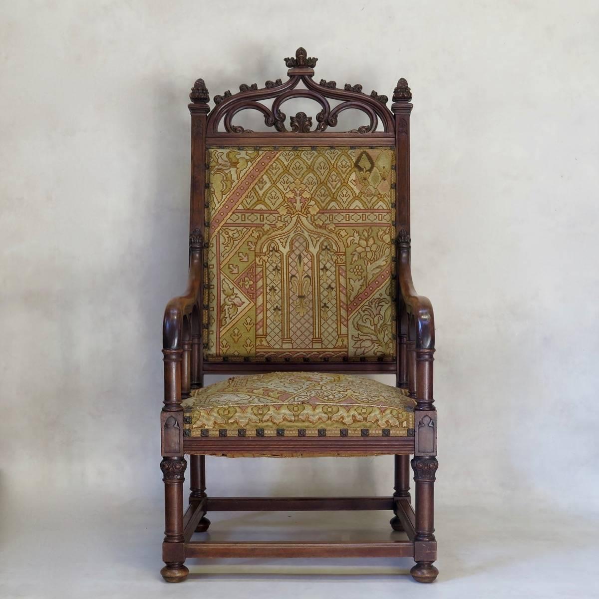Imposing pair of large neogothic hall chairs/armchairs, made of walnut, upholstered in petit-point tapestry.