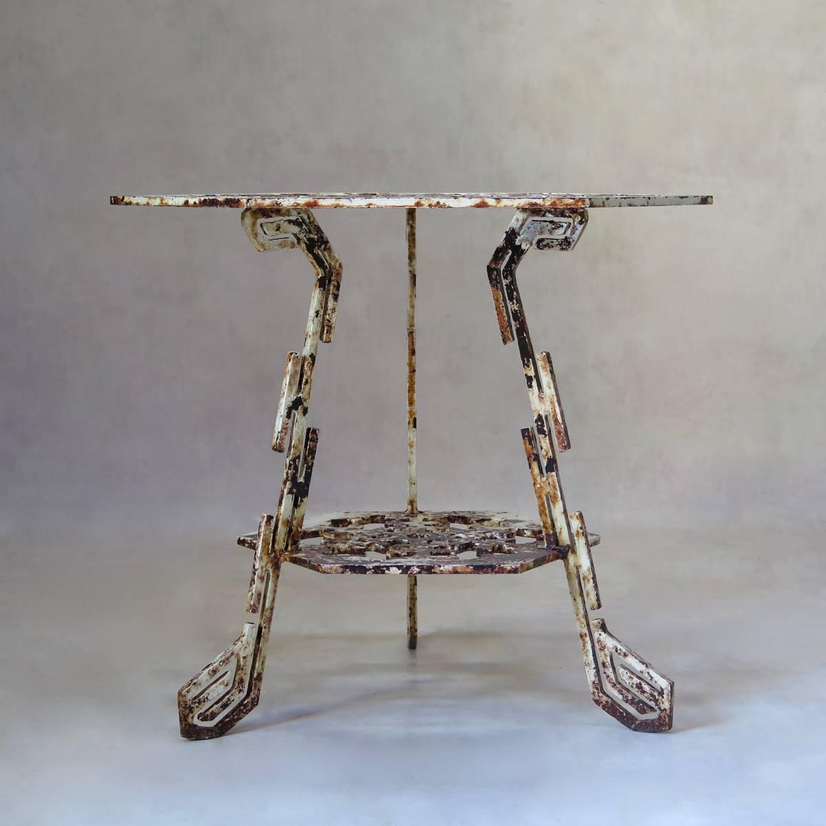 Unique, unusual and beautifully crafted and designed cast iron tripod gueridon with a hexagonal snowflake patterned top and lower tier. Original patina.