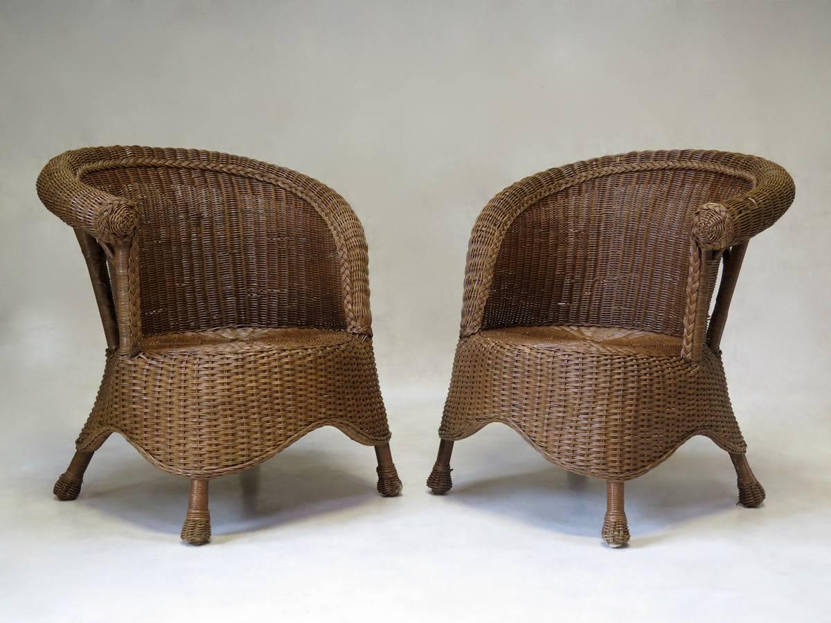 Handsome vintage rattan set comprising a small, round, two-tiered table and a pair of armchairs.
Dimensions provided below are for the armchairs.