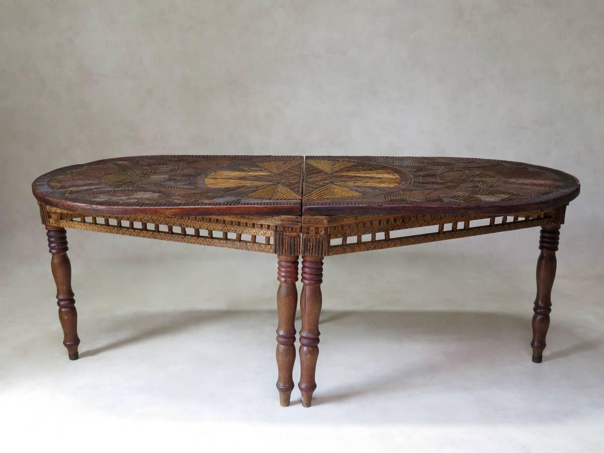 Unique and wonderful rustic 19th century centre table from France. The oblong tabletop is inlaid with an intricate geometric pattern, with contrasting-coloured smooth twigs. The apron supporting the top forms a losange, and is carved with a