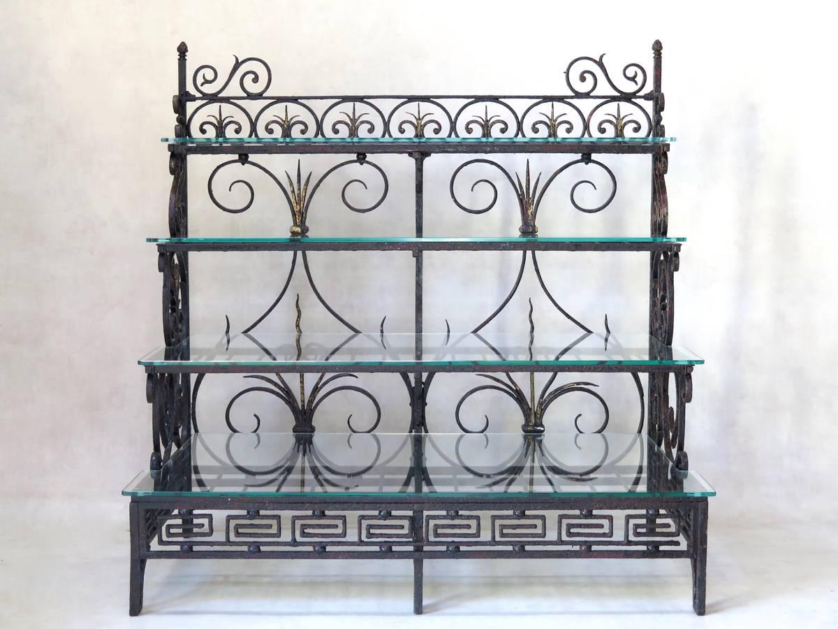 Unusual and elegant wrought iron shelves or plant-stand, dated from 1889, the year of the Exposition Universelle (World Fair) in Paris. The piece is decorated with stylised fleur-de-lys and Greek key motifs. Flame-top finials adorn each