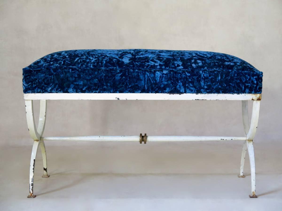 Art Deco bench with a painted wrought iron base and surround, with original white and gilt paint. Royal blue crushed velvet seat.