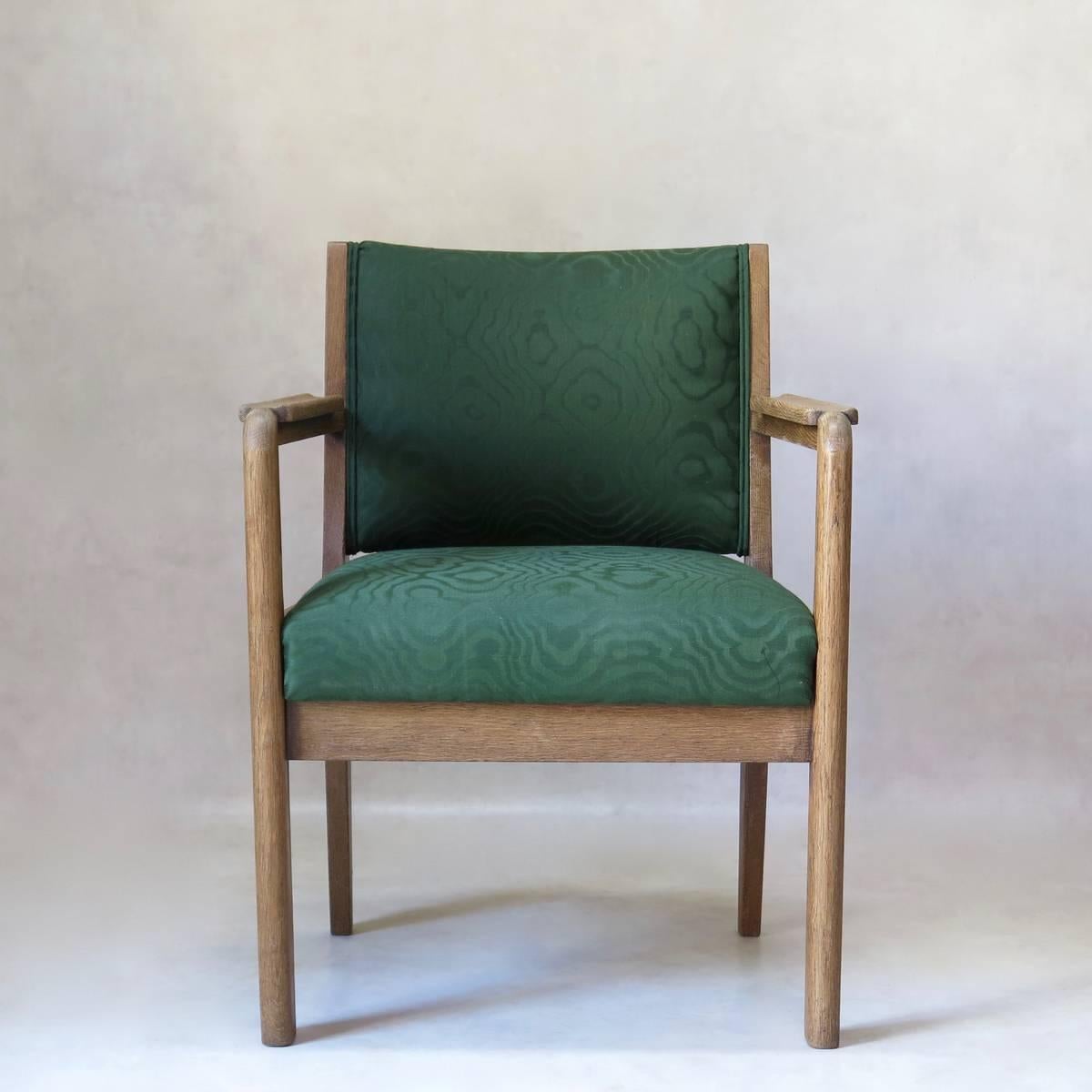 Large and comfortable brushed oak Art Deco armchair of very nice design. Upholstered in green moiré-like cotton fabric.