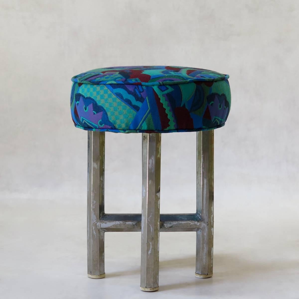 Compact but heavy Bauhaus stool raised on four chromed metal legs. The legs are octagonal and joined by an X-shape stretcher. Round seat upholstered in vibrant Art Deco fabric.
