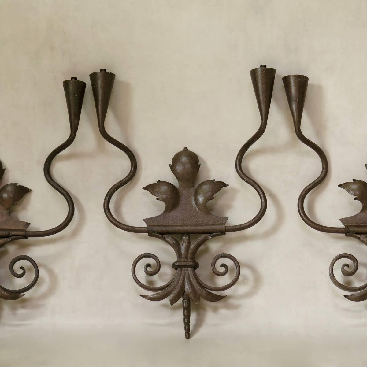Charming set of three iron wall lights with a coppery finish.