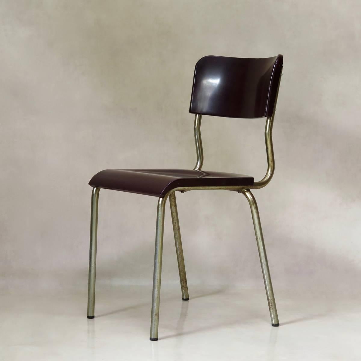Handsome set of Mid-Century chairs by French designer, René Herbst, known for his functional and Minimalist aesthetic. 
The seats and backs are of moulded bakelite, and the structures are chromed metal.
There are two colors: deep burgundy, and