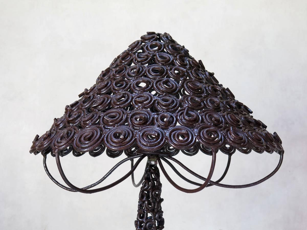 One-of-a-kind, large floor lamp, entirely handmade out of iron, which has been wrought into hundreds of spirals then assembled together to form the structure of the lamp.