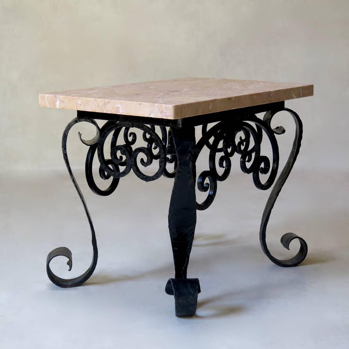 Baroque pair of side tables with wrought-iron bases, painted glossy black and pinky-yellow marble tops.