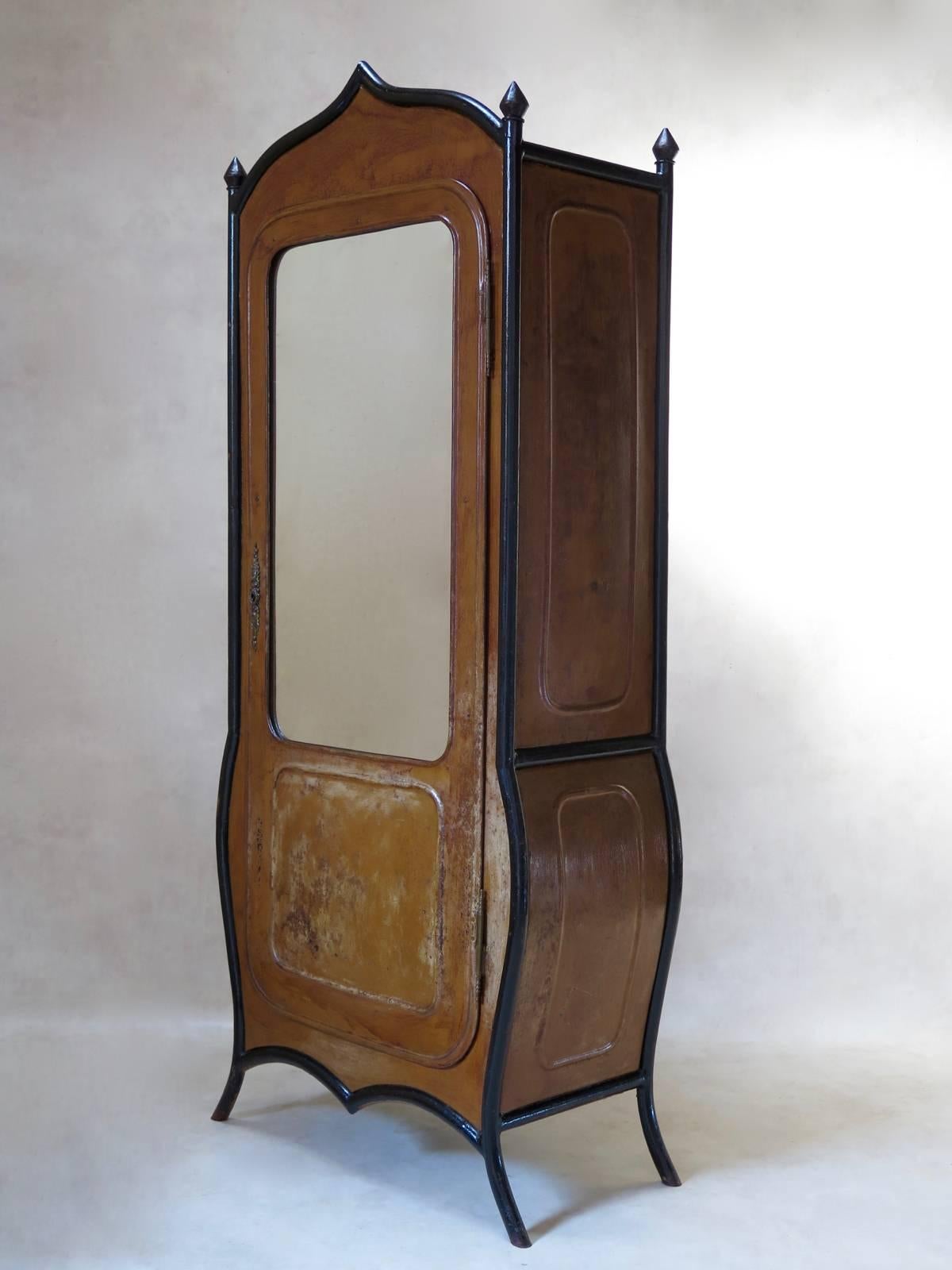 Very unusual Napoleon III iron cabinet, painted with a wood trompe-l'oeil. Elegantly outlined in black tubular iron, lending definition to its elegant lines: the bombé bottom section, the cabriole legs, and the ogee-shaped top, as well as the