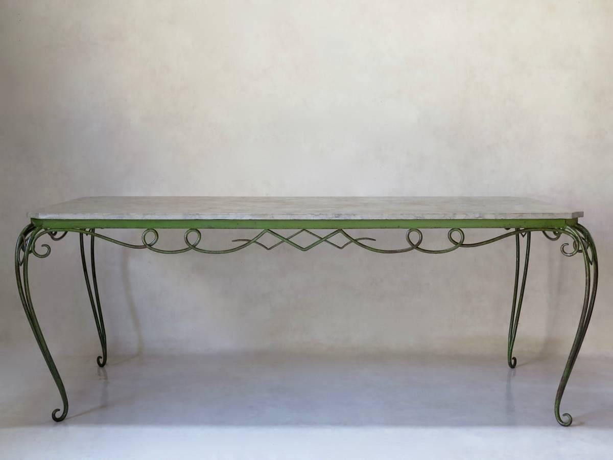 Very elegant Art Deco centre or dining table with canted corners a delicate, curlicue apron. Raised on double cabriole legs. Smooth stone top in soft, mottled grey/beige. The base has its lovely, original green paint.
