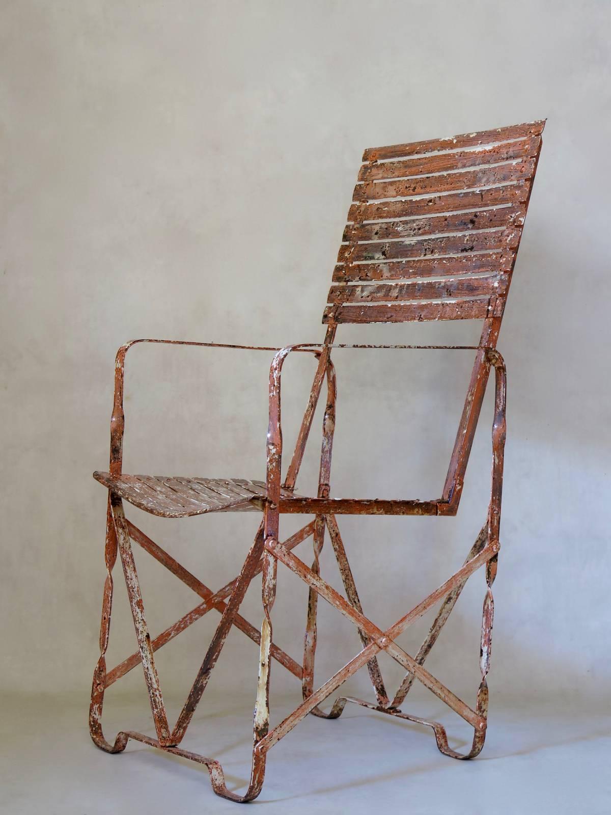 Unusual almost-pair of Industrial armchairs, entirely made from assembled parts that have been screwed and bolted together, much like Meccano. The bases are slightly different. Traces of the original white here and there, but mostly visible is the