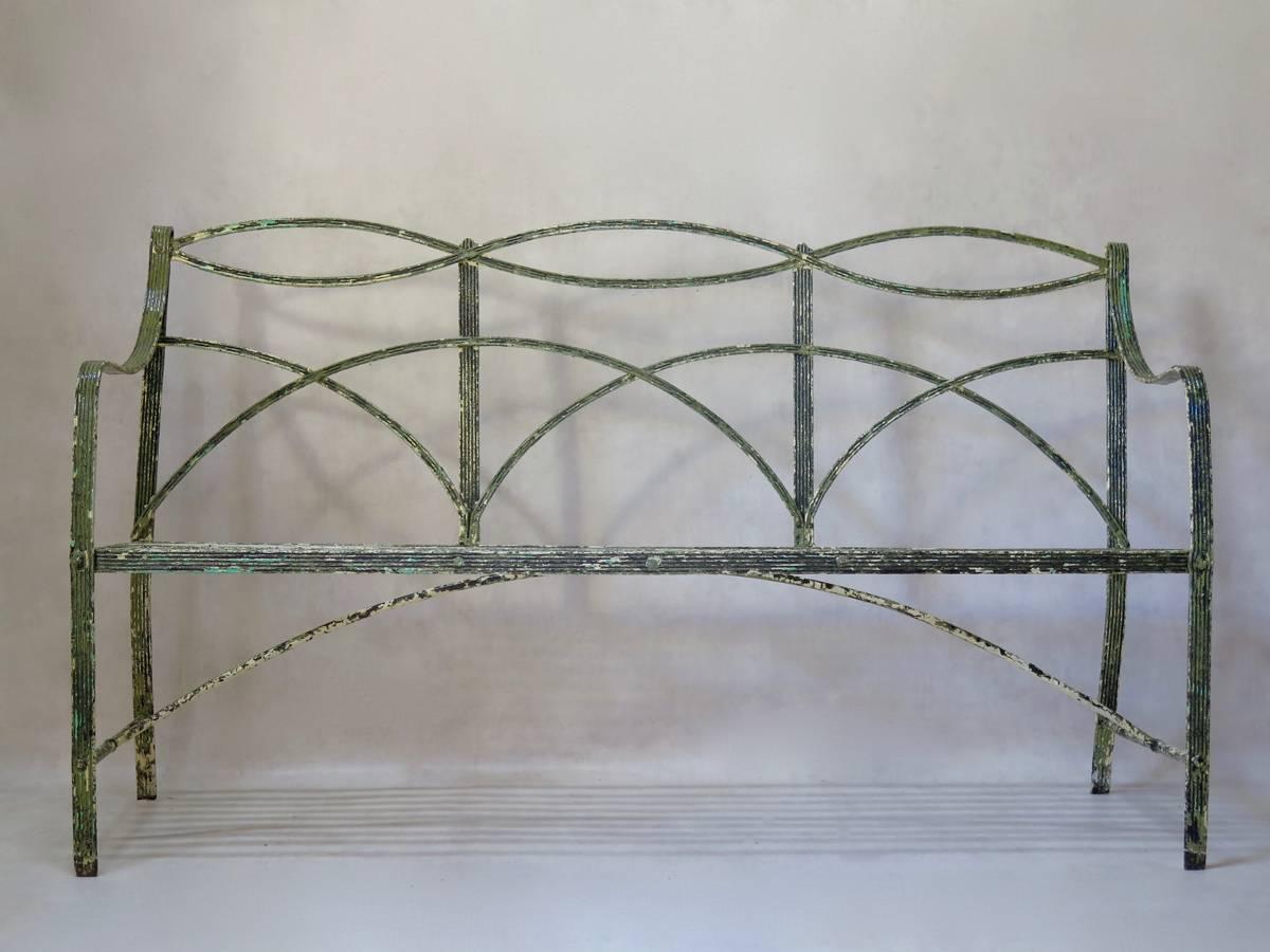 Very elegant antique riveted and wrought iron garden bench, with fabulous patina. Beautiful ironwork, of high quality. The bench is 200 years old and in wonderful condition.
