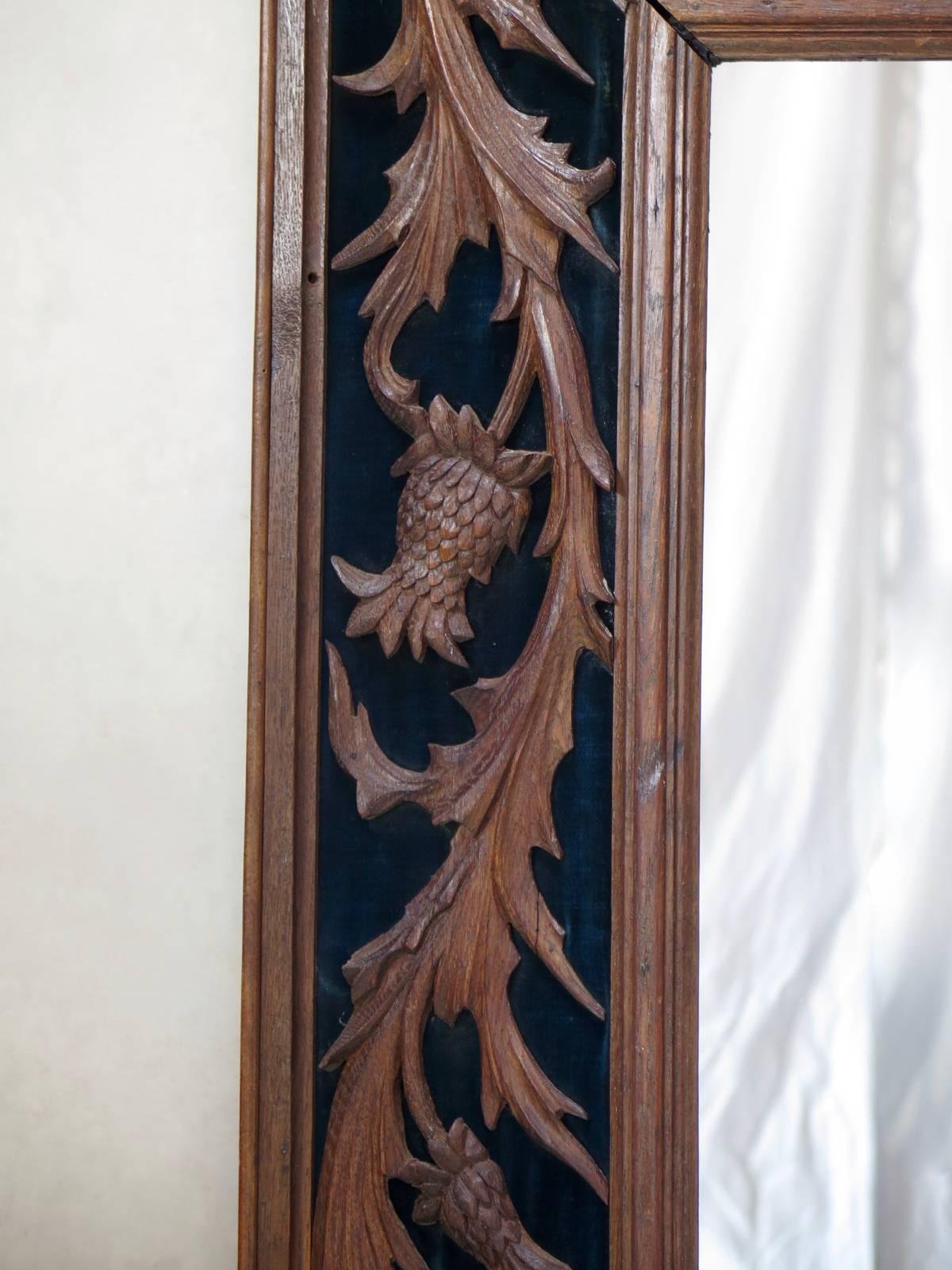 Large and gorgeous frame, with hand-carved thistles motifs applied to a deep teal blue velvet background. The wood is oak. New mirror.