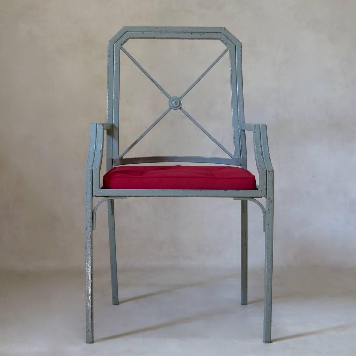 Set of four elegant Directoire-inspired iron chairs, painted grey, with red canvas seats. Very sturdy.