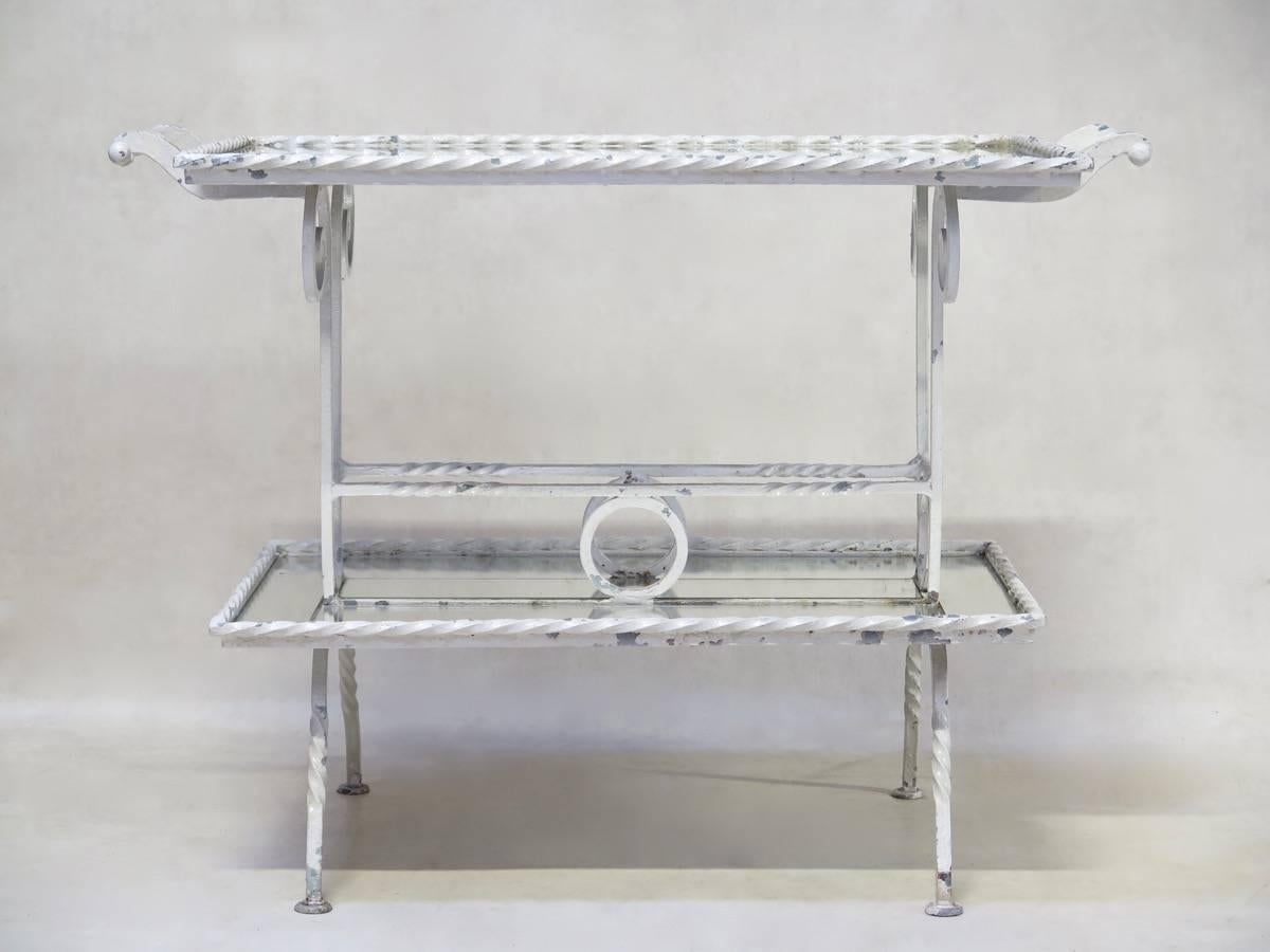 Elegant Art Deco drink’s table from the 1940s, with twisted wrought-iron detail. Solid and heavy piece, with mirrored tiers.