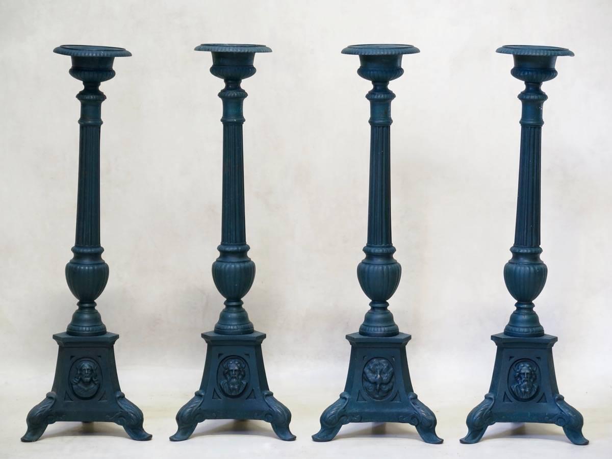 Elegant set of four iron prickets, with a verdigris patina. 