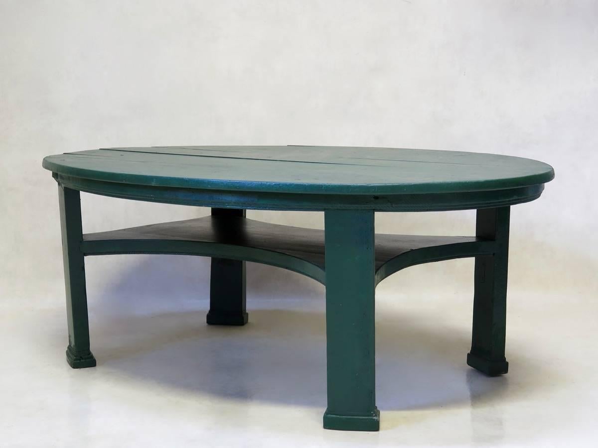 Large oval pinewood coffee table of elegant proportions, painted green.