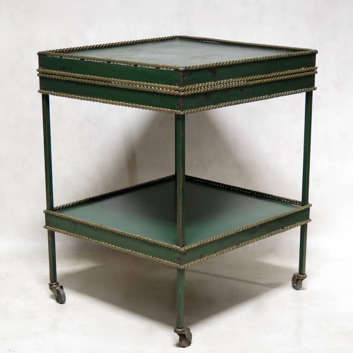Unusual, two-tiered table made of iron tole, painted green, with a gilt, twisted rope surround.