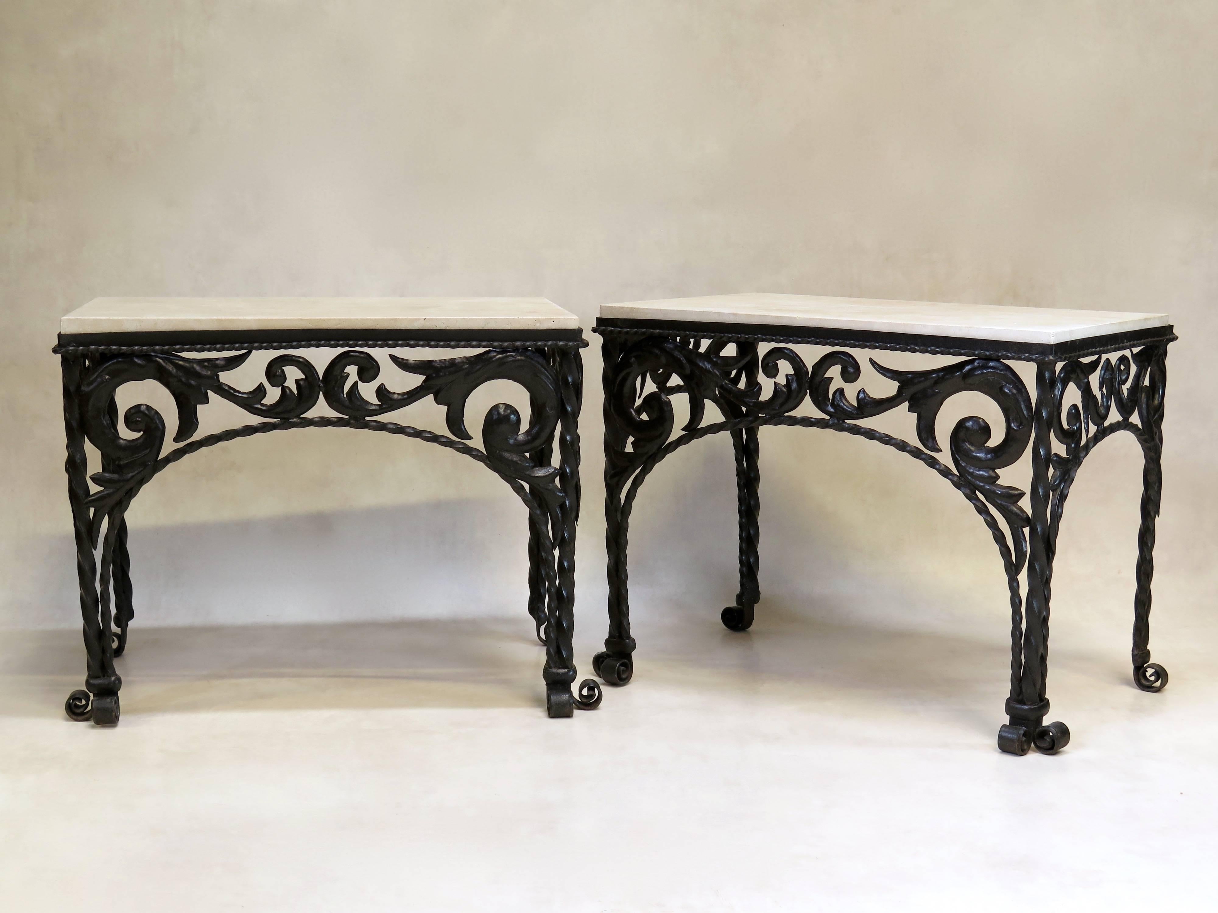 Lovely and heavy pair of unusual, solid iron tables with a foliate decor and twisted iron legs ending in scrolled feet. The apron runs around three sides.

Travertine tops.