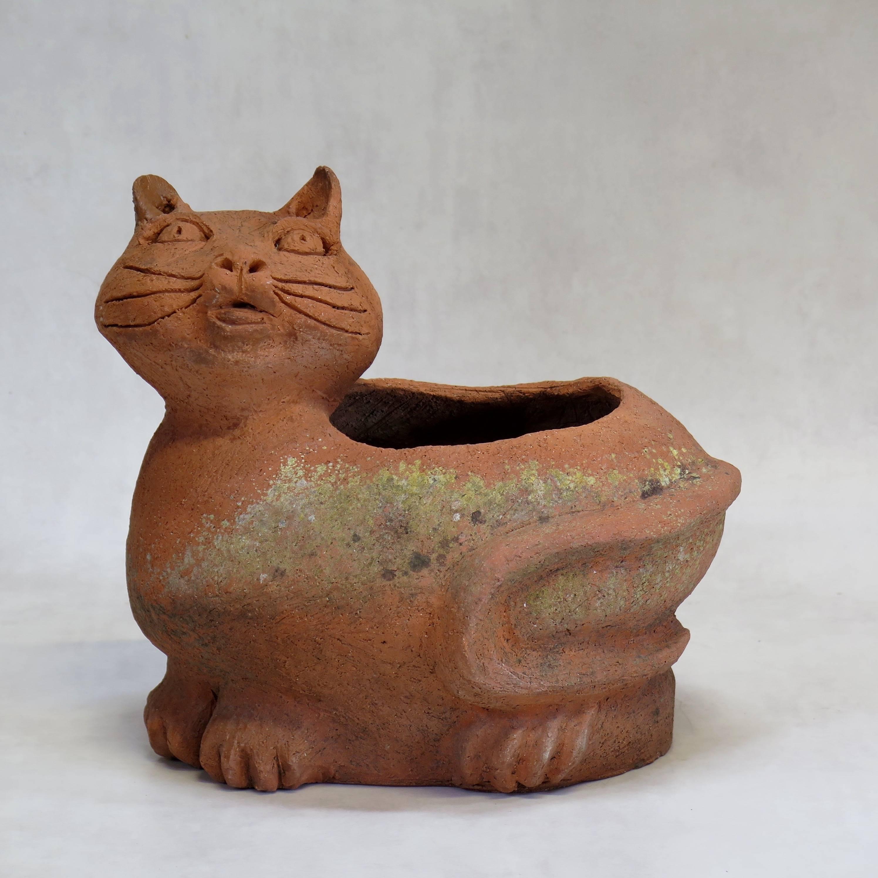 Very cute and quirky pair of cat and dog terracotta planters, with a nice patina.

Signed on the base 