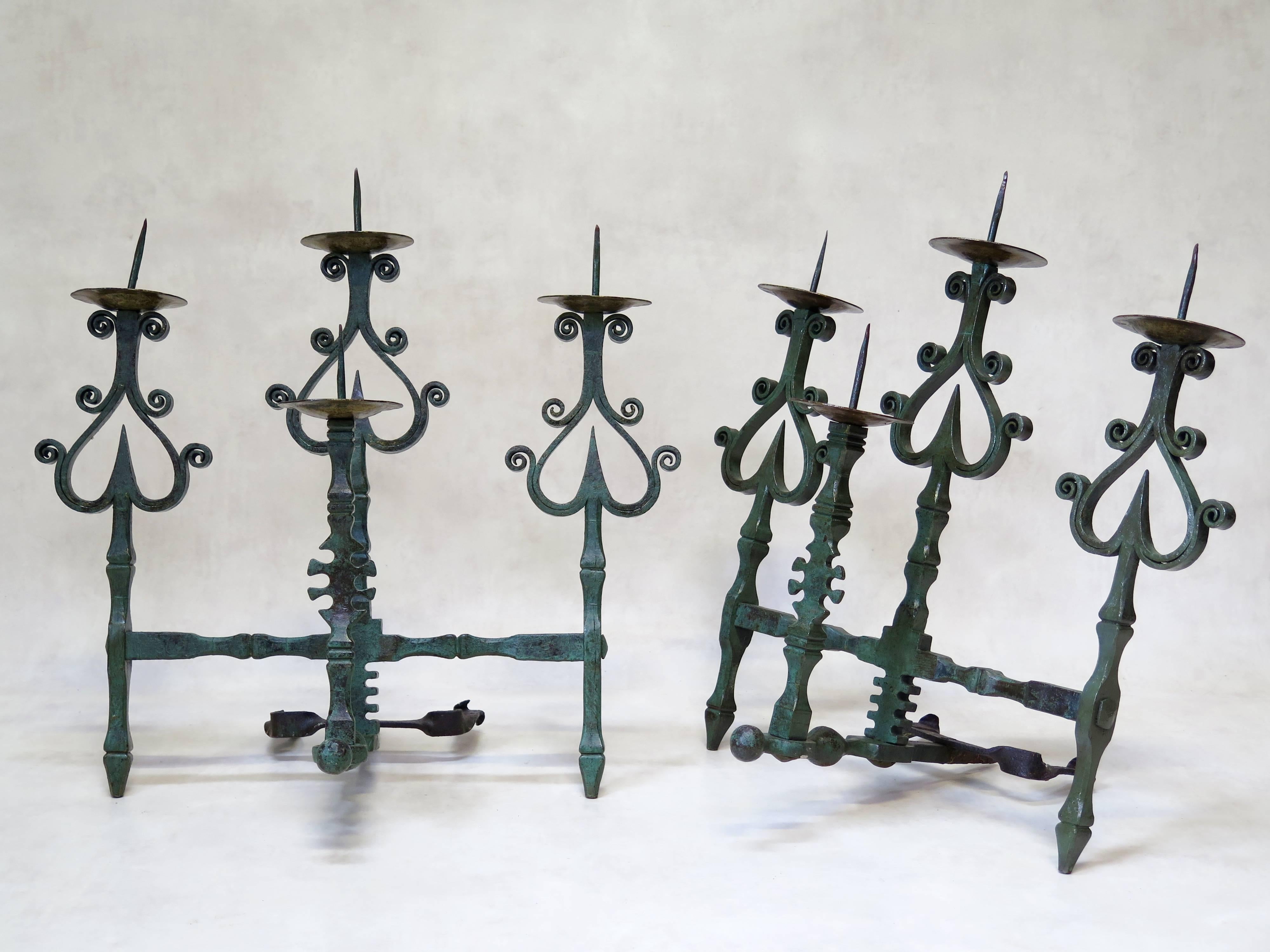 Stunning pair of unusual mural candleholders in heavy hand-wrought iron with a lovely Verdigris patina. Each candleholder holds four candles.