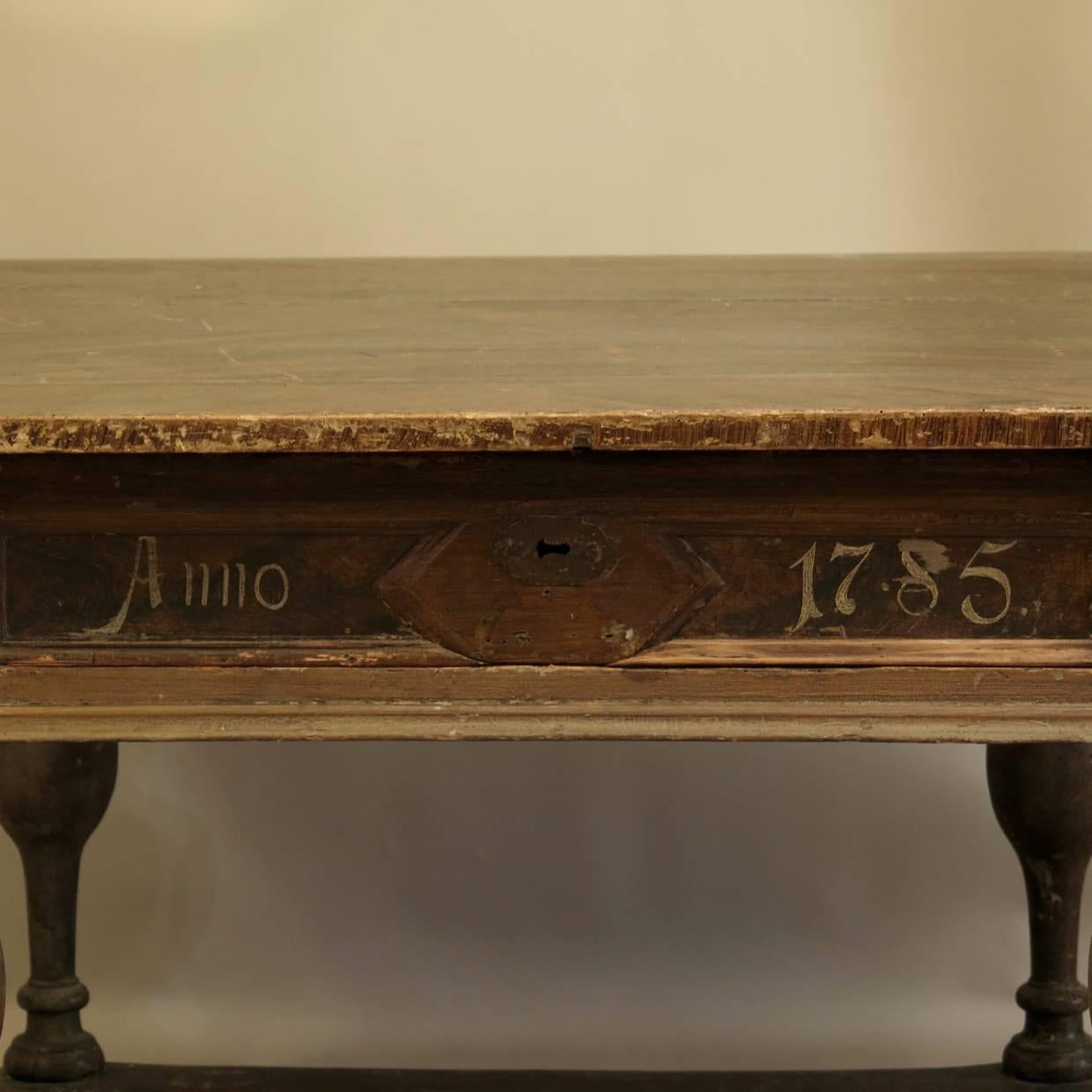 Rare and wonderful painted table with a square top, raised on baluster legs with a surround stretcher. Deep drawer in the recessed apron, with the date painted: 