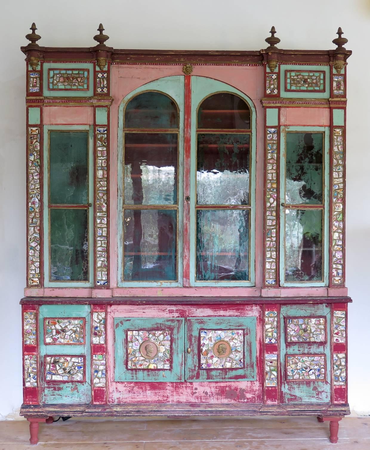 Rare and unusual dresser decorated with colorful bits of broken porcelain -- in typical French Folk Art tradition, but unusual on a piece of this size -- and painted pink, red and green, with gold touches here and there. This piece of furniture is