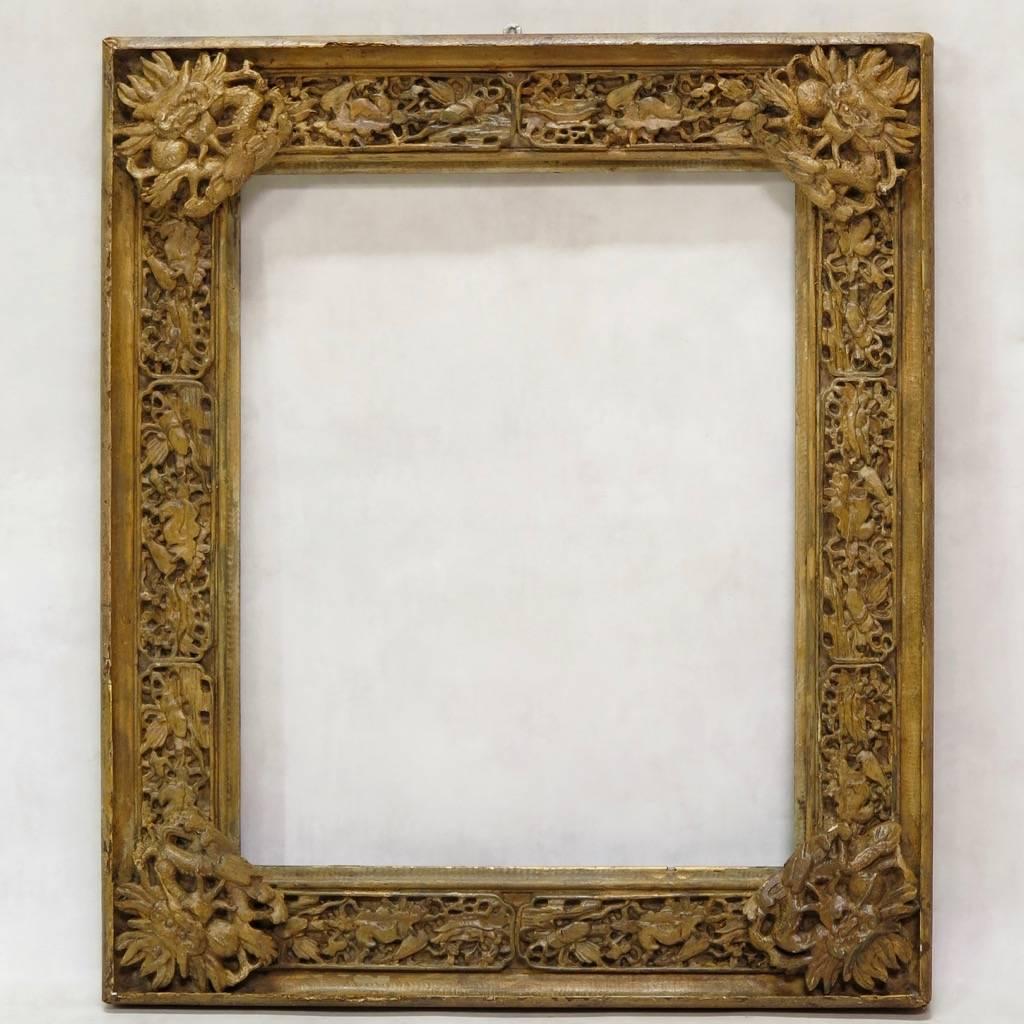 An unusual and beautifully-carved wood frame. The carvings are in relief, so that the frame is quite deep. Original, ochre-yellow color. The piece has acquired a nice patina.