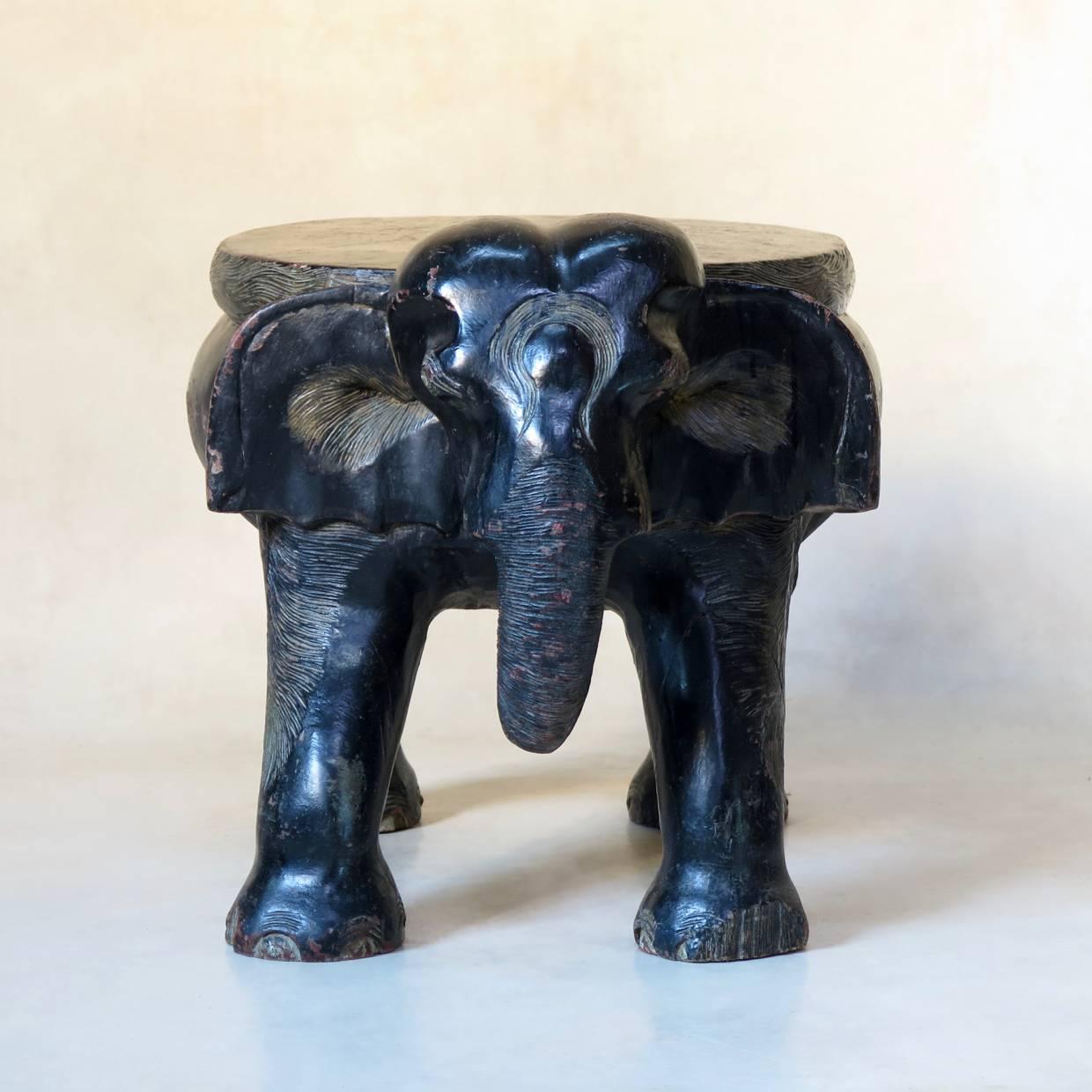 Heavy and pleasantly rotund elephant-shaped stool / side table, made from a dense, exotic wood with a nicely patinated ebonized finish.