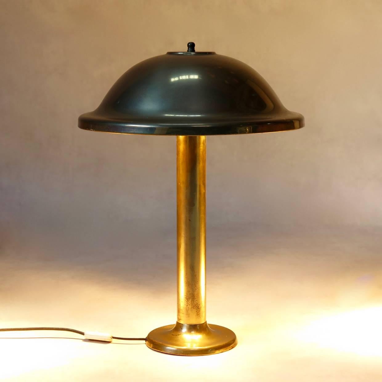 Beautiful, tall desk lamp of elegant, simple design, with a dome-shaped shade, raised on a stem base. The shade holds two bulbs. Rather heavy.