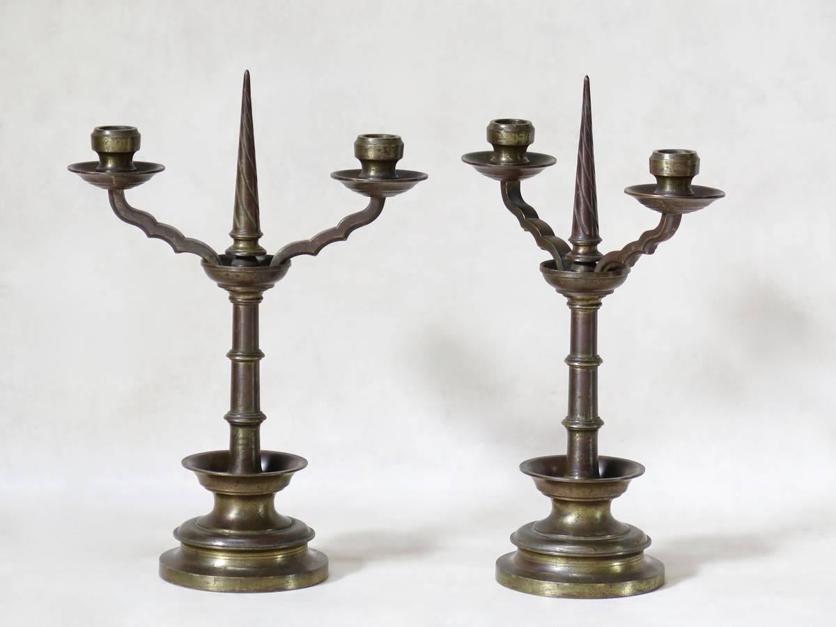 Heavy and nice quality pair of gilt bronze neo-Gothic candleholders, with an elegant turned spire and a chunky, turned base.