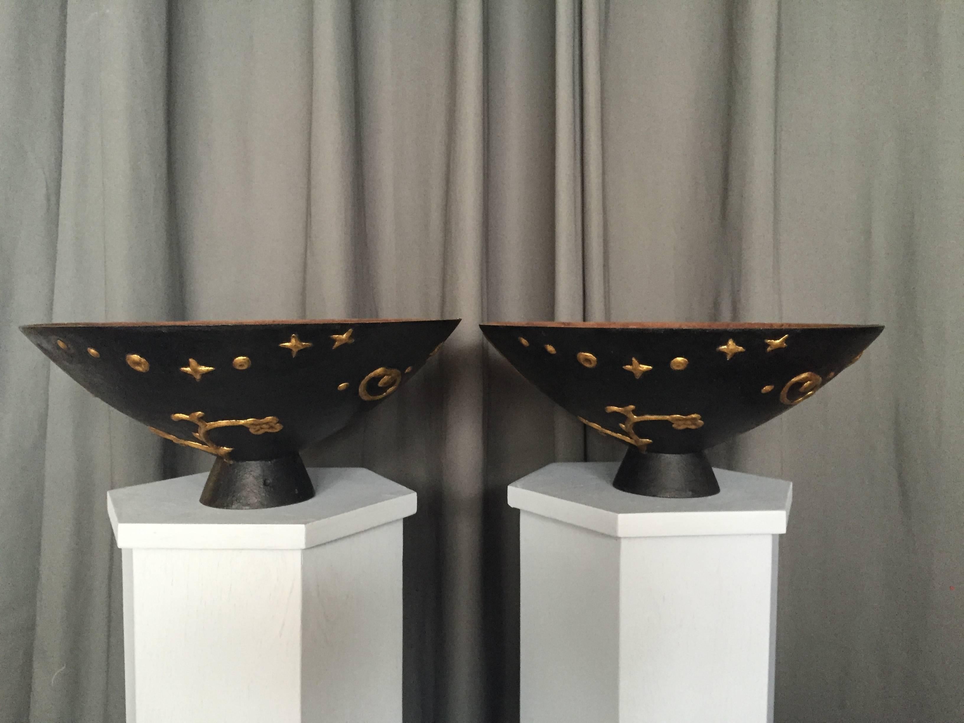 A pair of cast iron urns “Mikrokosmos” designed by Olof Hult (1892-1962) for Nafveqvarns Bruk, Sweden, designed 1922, executed 1920s-1930s. Gilded and painted later. Height 7