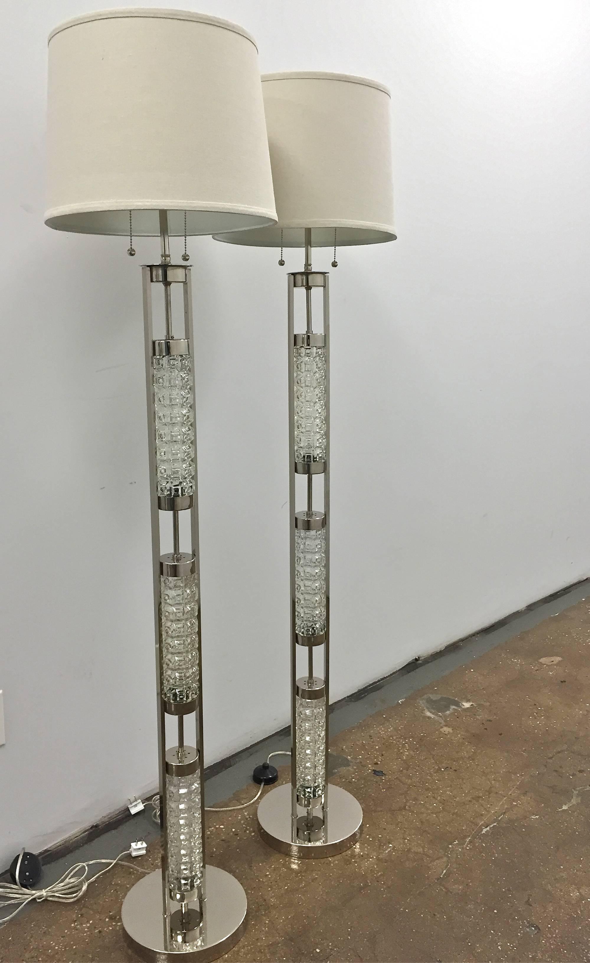 A pair of vintage Scandinavian floor lamps is the Orrefors style.
Textured clear glass and polished metal. Newly restored and rewired, ready for use. The shades not included.
