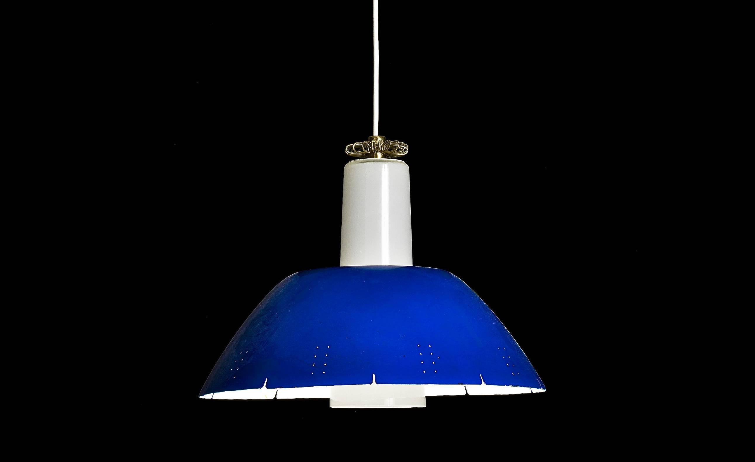 The  pendant designed by Paavo Tynell for Idman, Finland, circa 1950s. Perforated painted metal shade with opal glass shade and brass decoration. Marked -