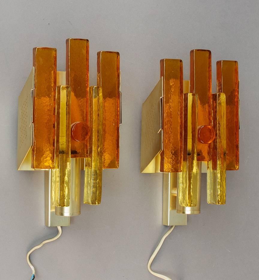 A pair of Danish wall lights, Denmark, circa 1960. Design attributed to Svend Aage Holm Sorensen. Tinted glass and brass. Measures: Height 12.5