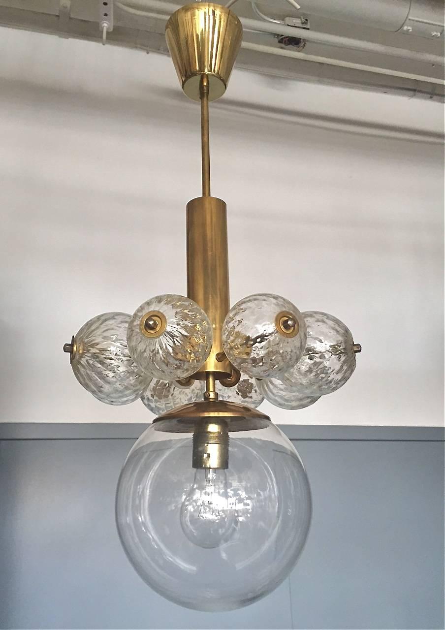 A pair of pendants attributed to Kamenicky Senov manufacture. Czech, circa 1950s. Brass and handblown glass. 
Existing electrical wiring, we do not guaranty functionality, rewiring available upon request.

