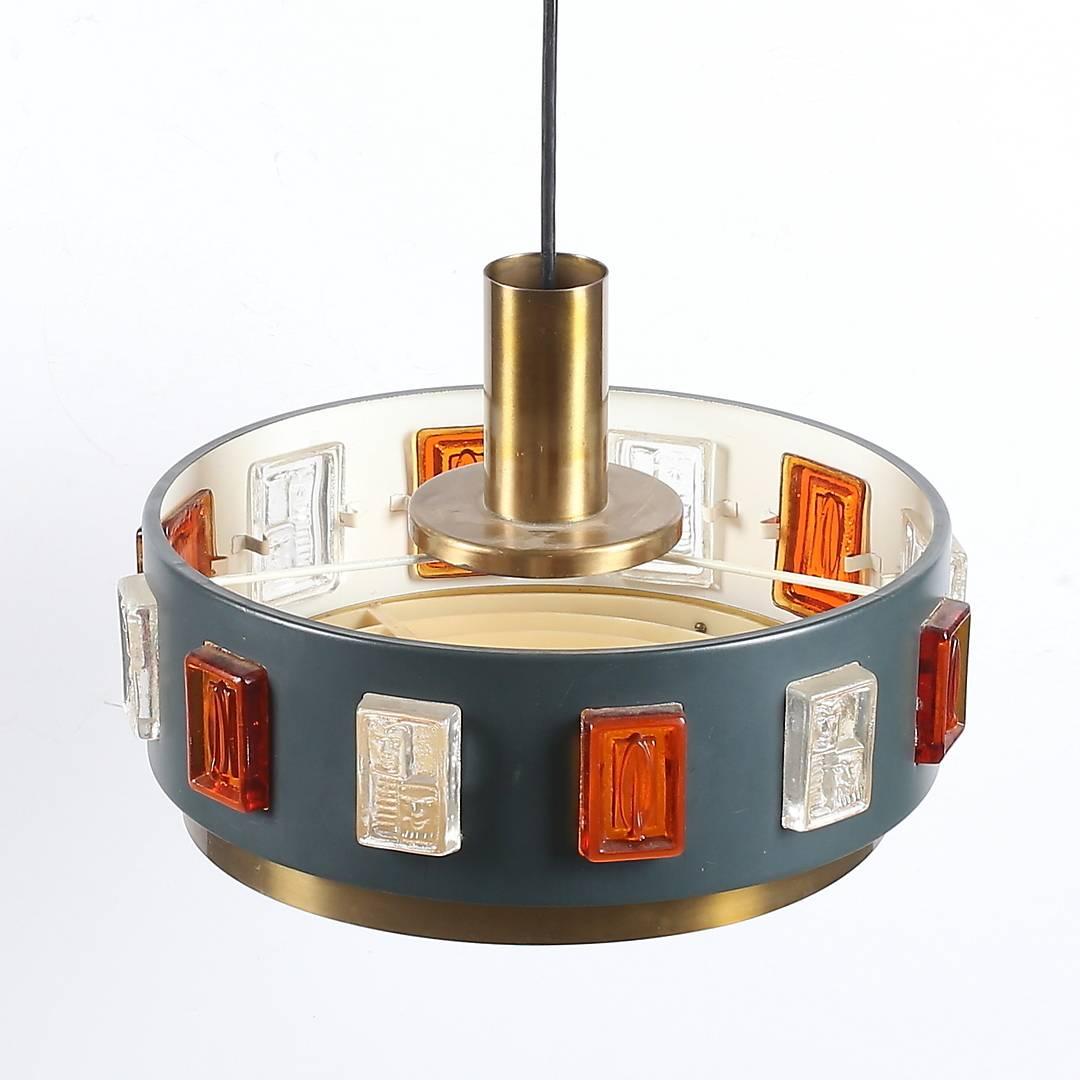 A pendant by Erik Hoglund, Sweden, circa 1970.
Brass, paint metal and hand blown glass decoration.
Existing wiring, rewiring available upon request.
2 Fixtures available, price is for each.
 