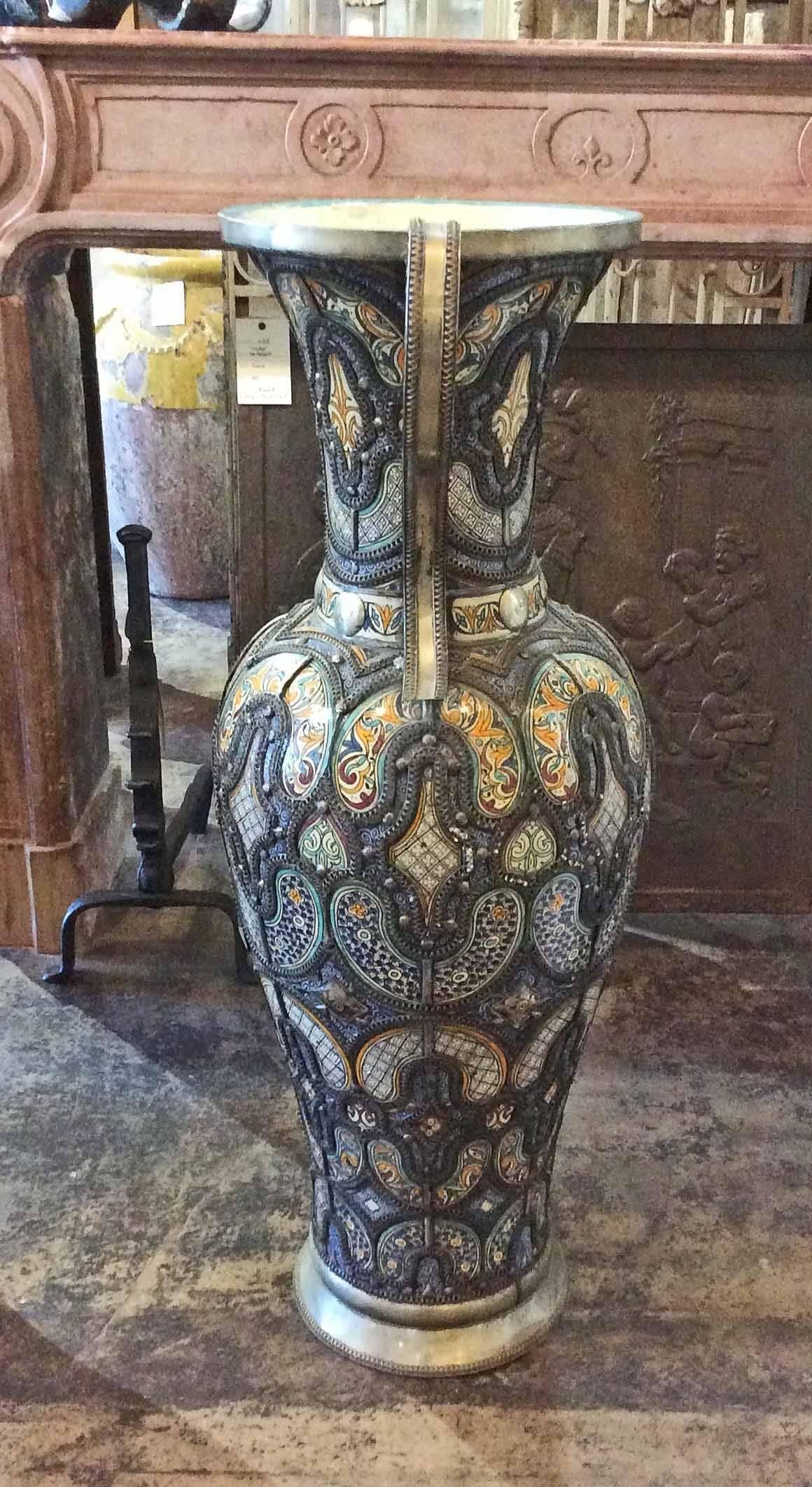 
An outstanding and unique large touareg moroccan vase. This vase was made in Fes, and the hand tooled led metal was made in Marrakesh, a marriage of two cultures.

Origin: Morocco 

circa 1870

Measurements: 41 1/2
