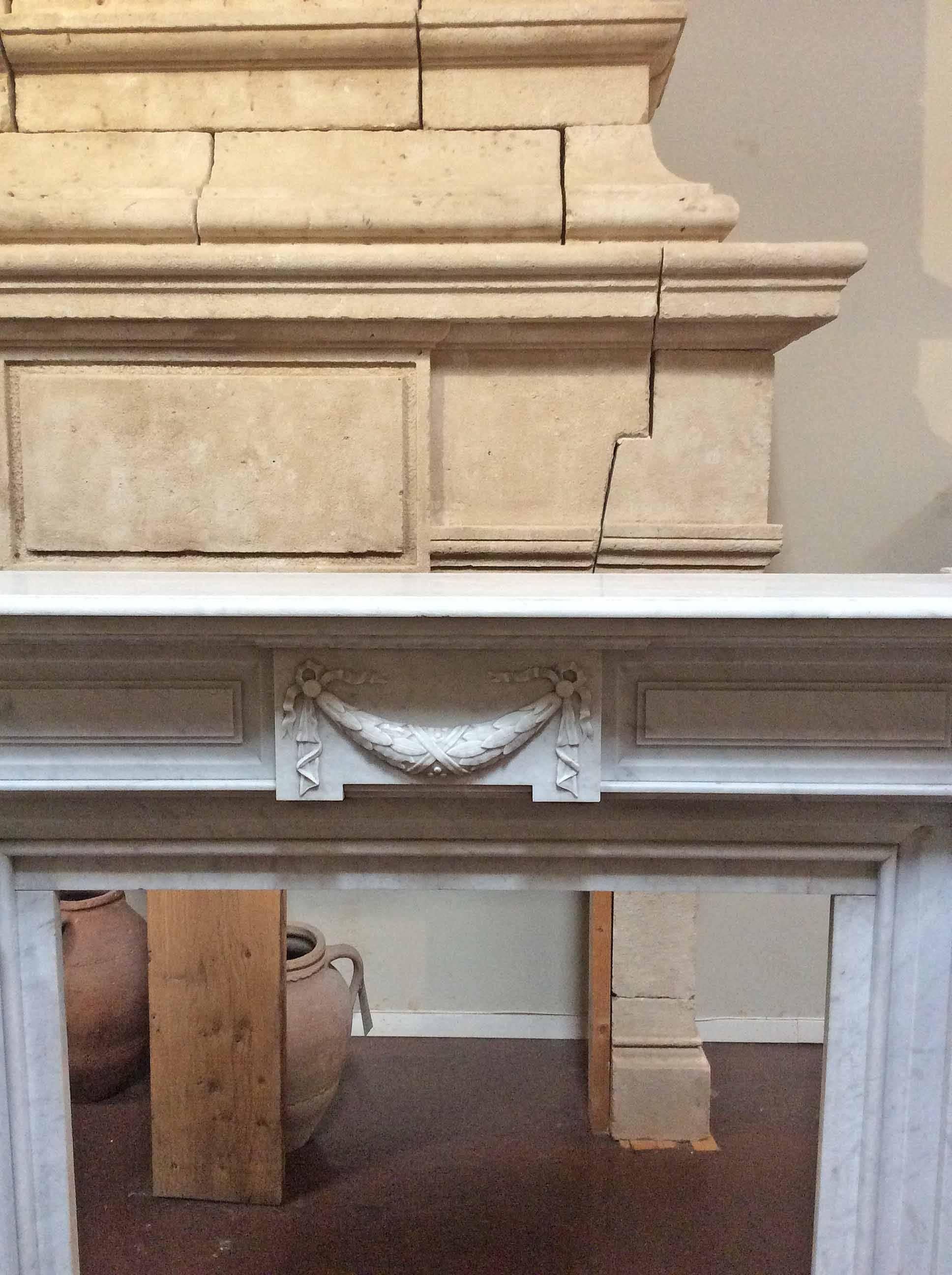 This Louis XVI white antique marble mantel features fluted legs, rosettes and hand carvings that create wonderful movement without distracting from the nice clean lines. 

Origin: France,

 circa 1850.

 Measurements: 67