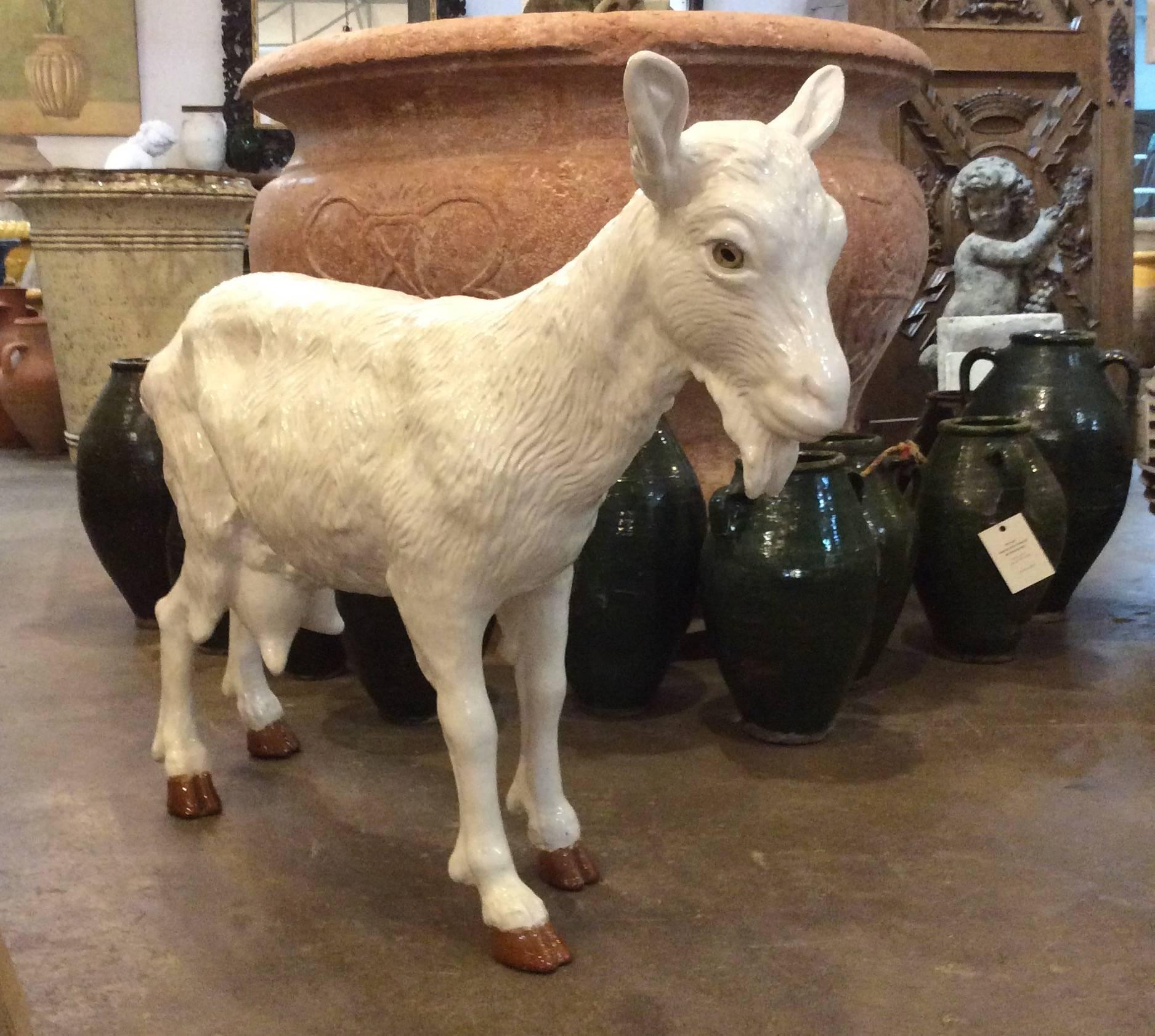 This pair of wonderful porcelain goats features glass eyes and will add charm to your courtyard. 

Origin: France.

 Mid-Century.

Measurements: (Standing) 41