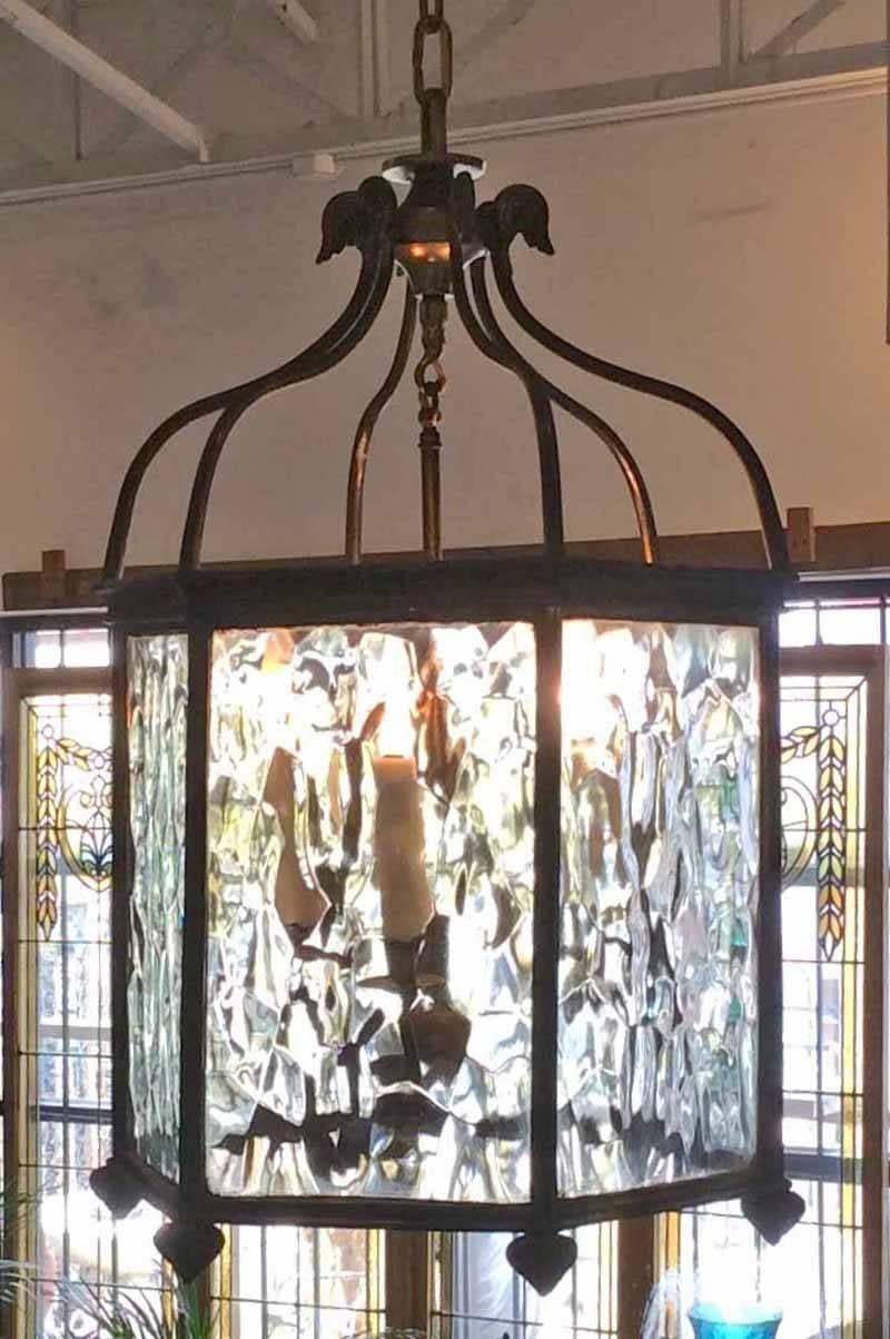 Mid-Century octagonal bronze lantern features 3 lt. and hammered glass in great condition. 

Origin: France. 

Mid-Century. 

Measurements: 28
