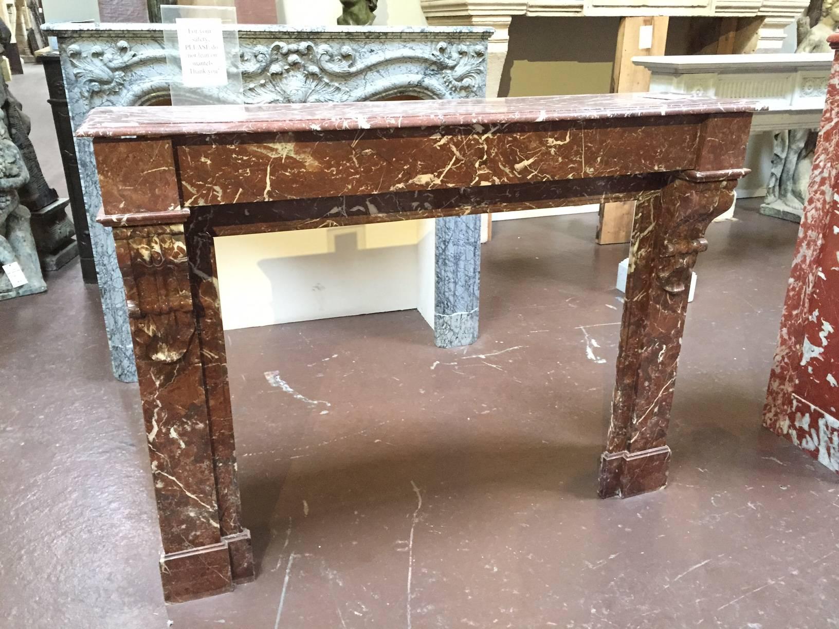 This antique mantel is made form Griotte rouge de belgique marble and fears a simple lintel as well as a scroll-like design on the top of each leg.

 Origin: France, 

circa 1880.

 Measurements: 54