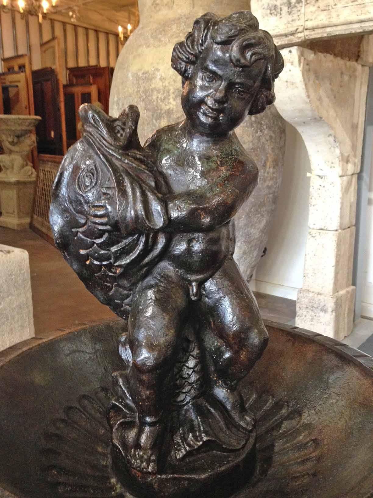 This cast iron fountain features a boy with dolphins, fanciful with a lot of personality for your garden.

 Origin: France, 

circa 1880 

Measurements: 24