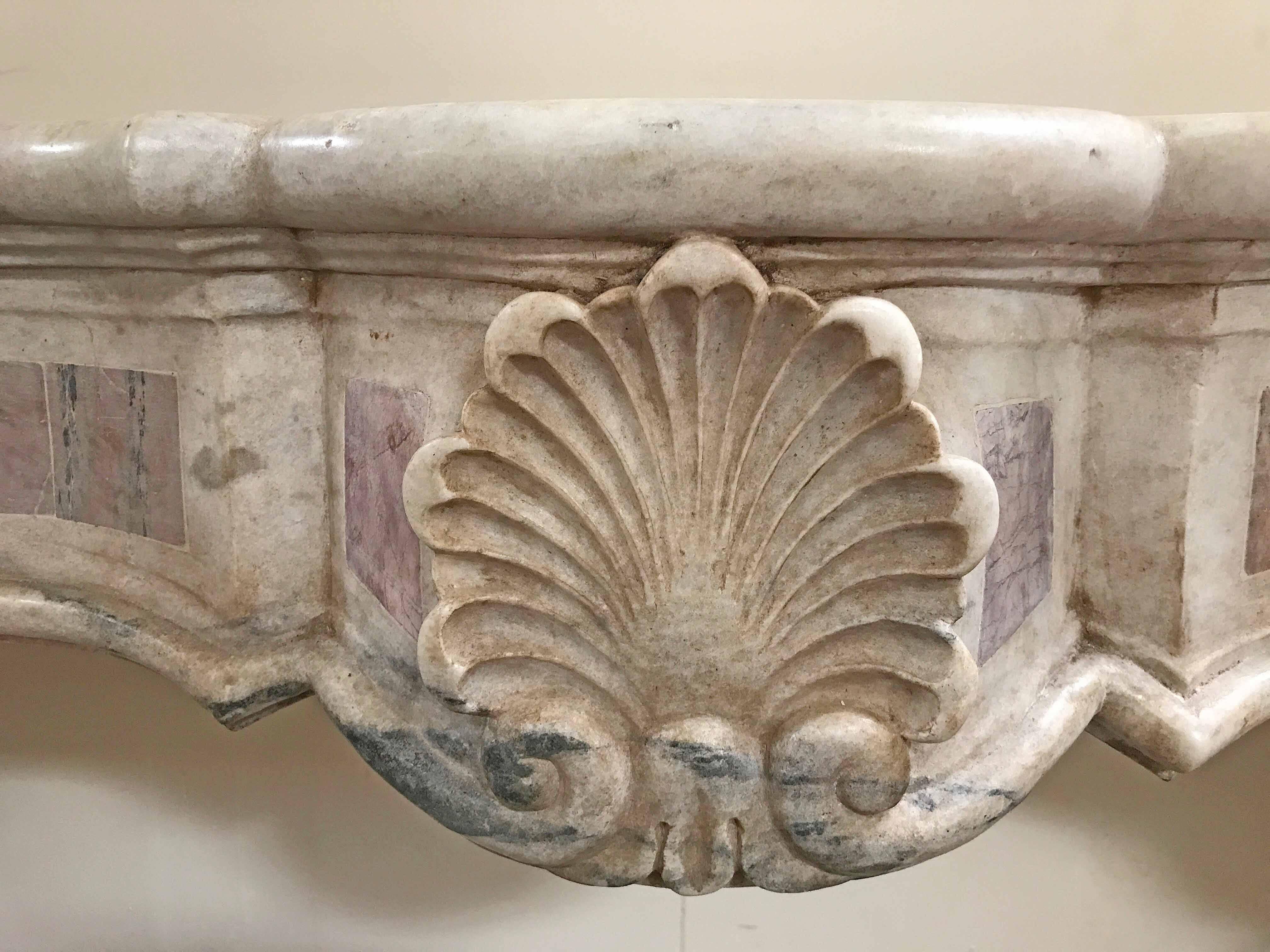 Antique marble mantel with lotus decor

Origin: Venice, Italy, 

circa 1800s

Measurements: 59" W x 10" D x 51.5" H firebox: 42" W x 42" H.
