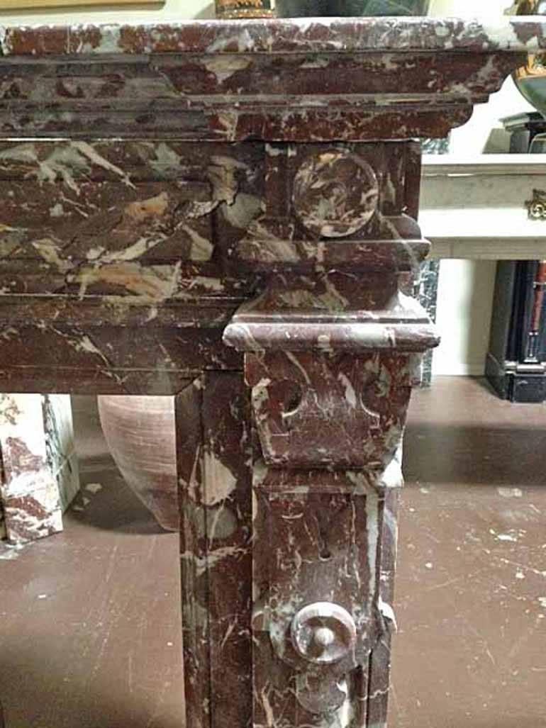 Red marble mantel with white veins and geometric designs.

Origin: France, 

circa 1860. 

Measurements: 54