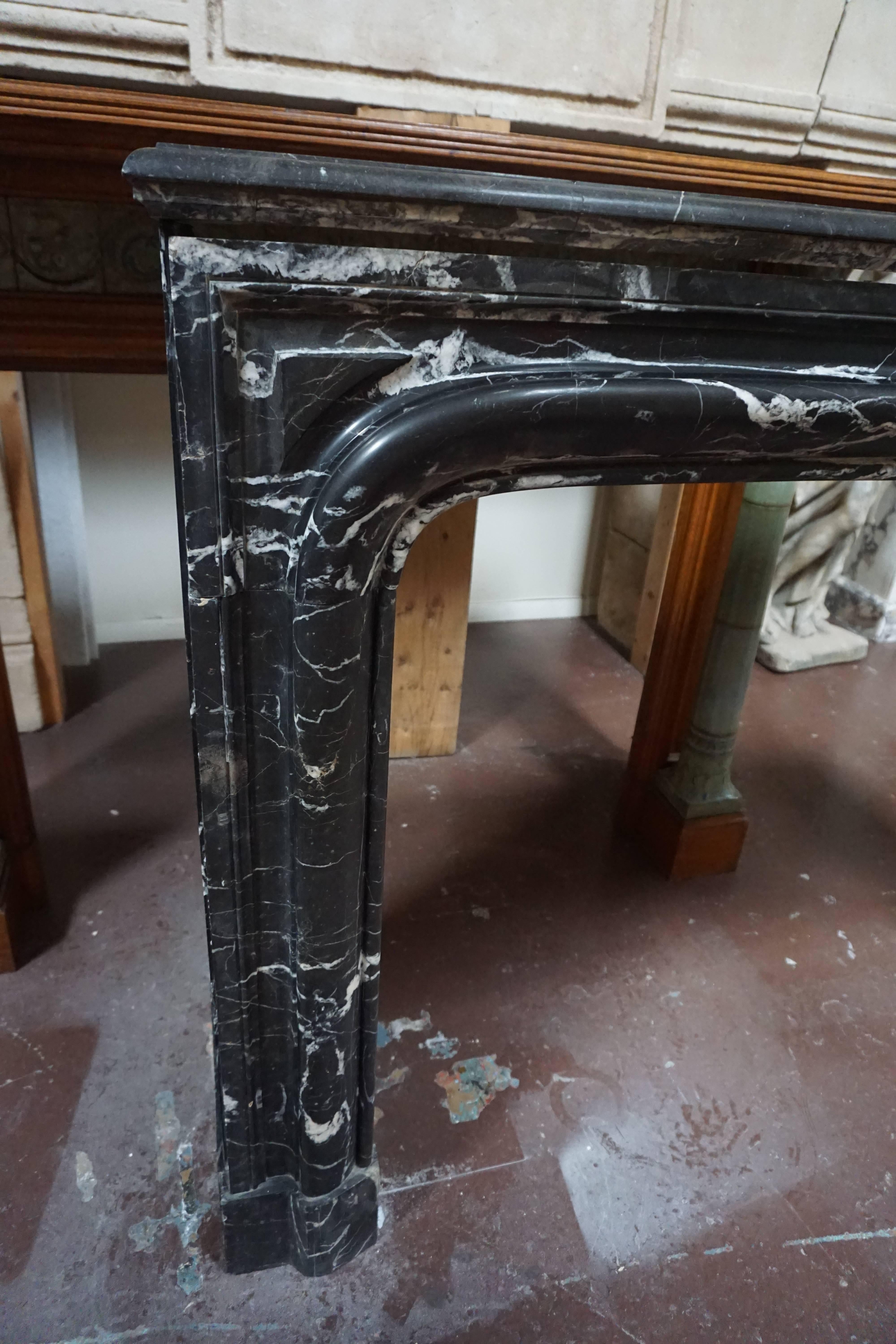 Louis XIV-Style Bolection Molded Black Saint Martin Marble Mantel In Excellent Condition In Dallas, TX