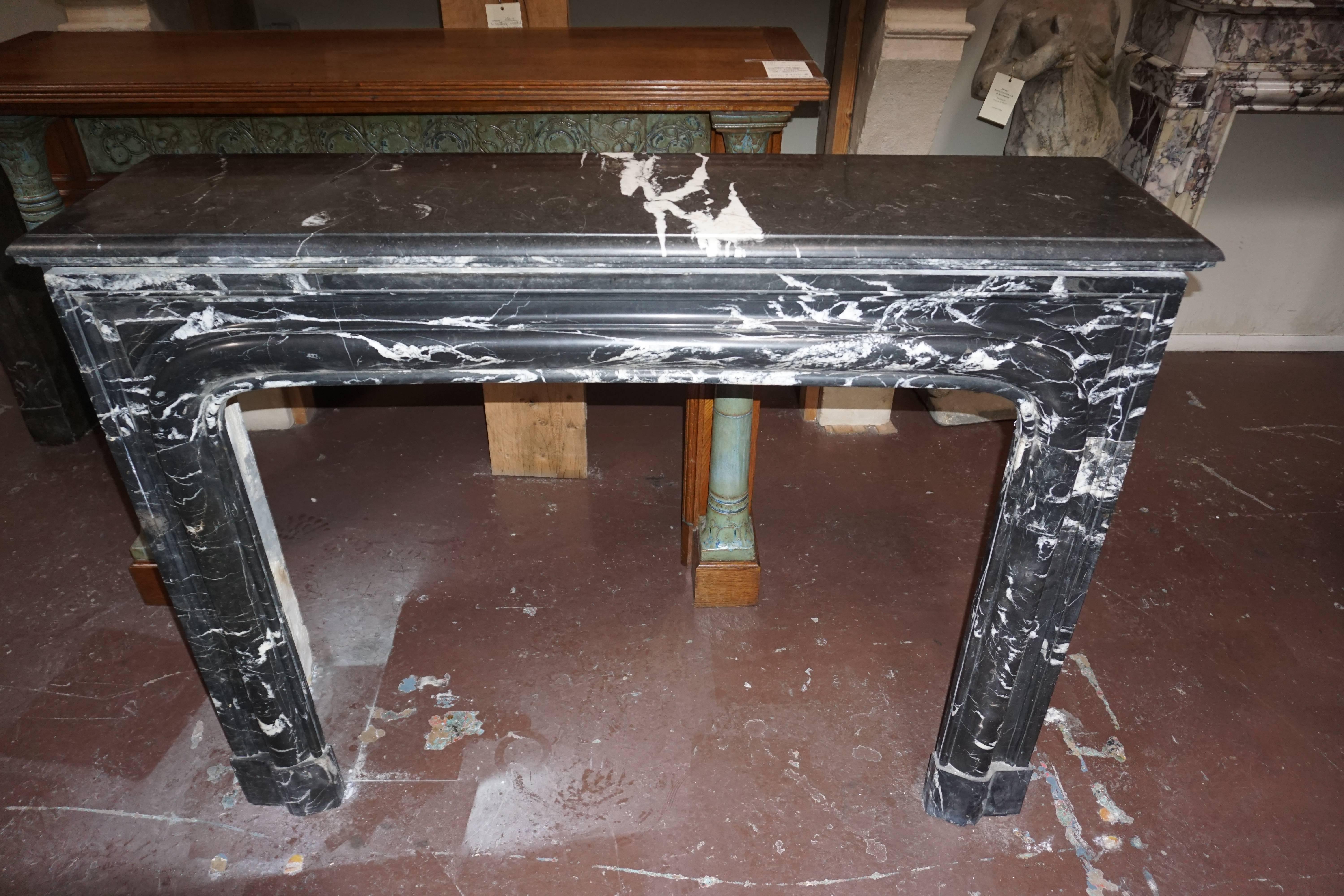 Hand-Carved Louis XIV-Style Bolection Molded Black Saint Martin Marble Mantel