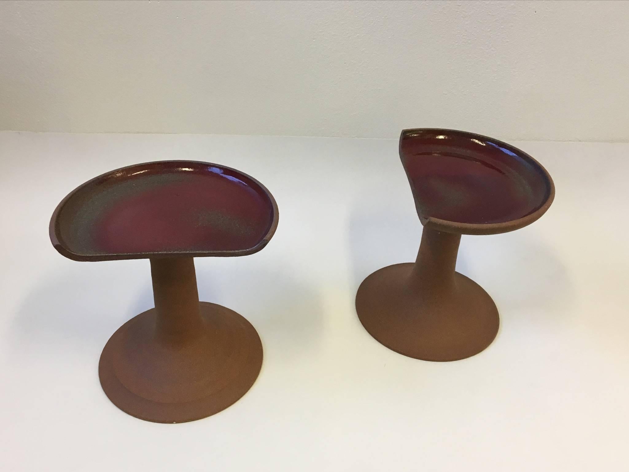 A beautiful pair of studio ceramic stools by renowned California ceramicist Brent Bennett. If you need more let us know.
The seat top is glazed with a transparent burgundy. 
Dimensions: 16