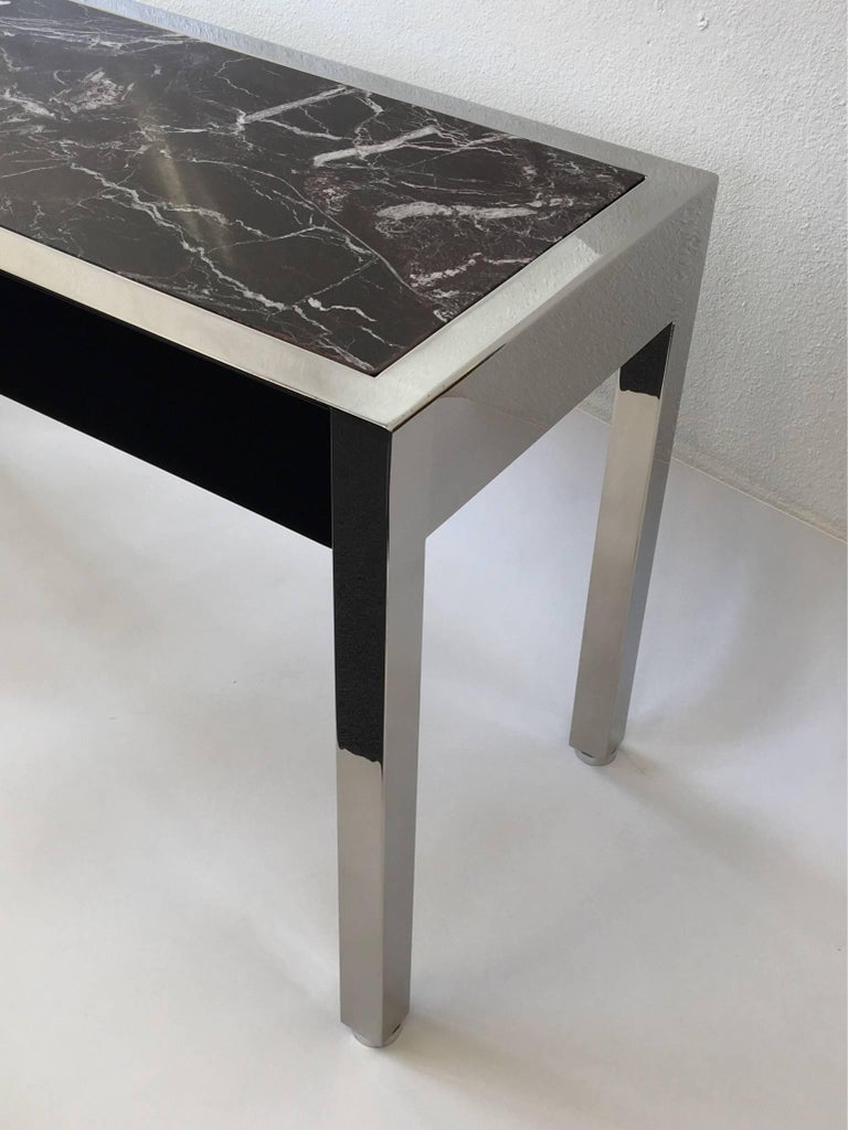 A rare polished stainless steel, Rosso Levanto burgundy marble with two drawers that are high gloss black lacquer. Designed by Leon Rosen for Pace Collection in the 1980s. It retains the Pace Collection tag on one of the drawers.
The Marble insert